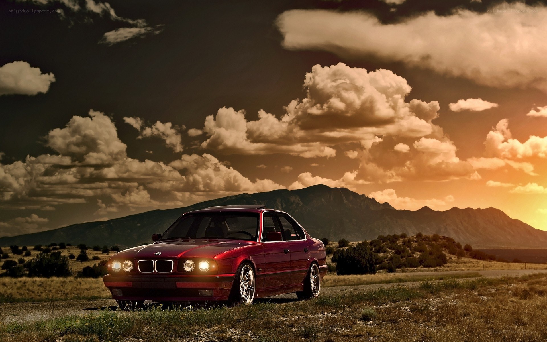 Red BMW on a desert road