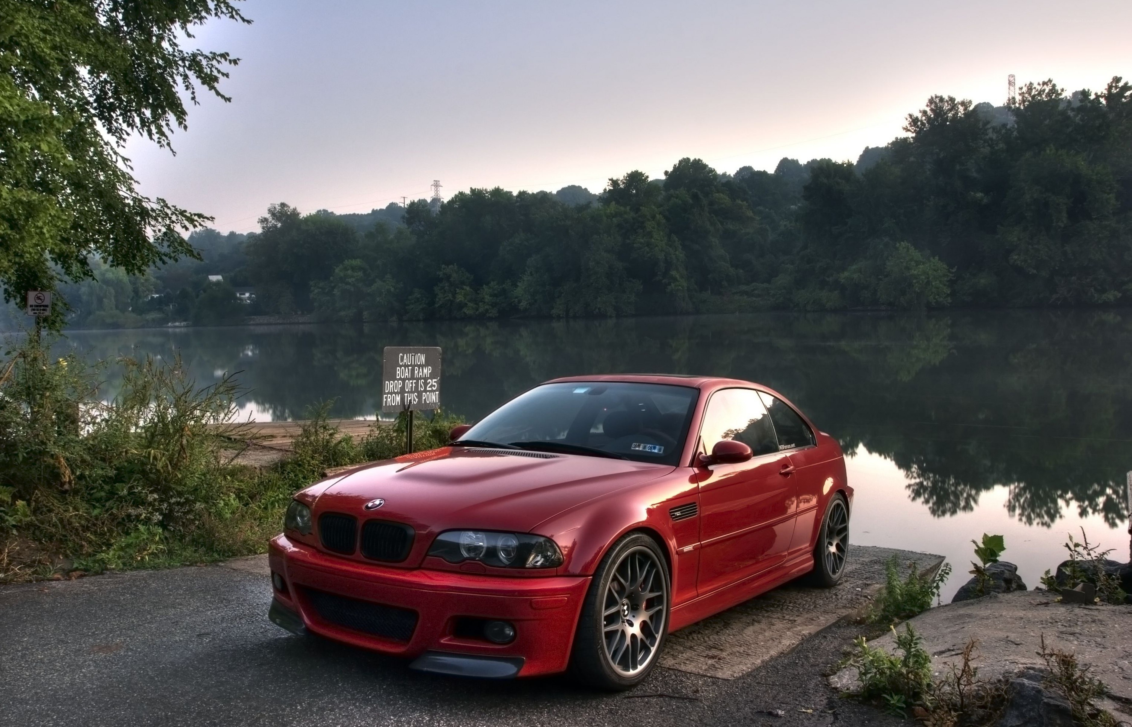 Red BMW on a lakeside ramp