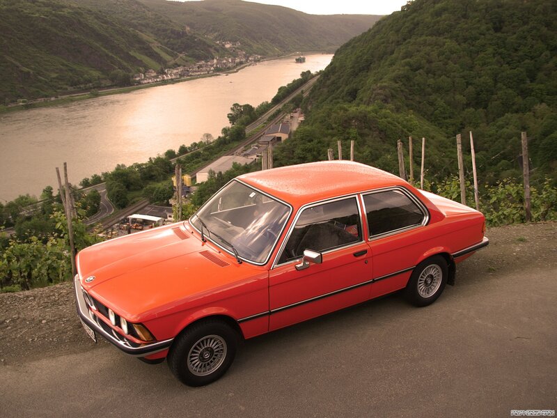 Red BMW on a scenic overlook