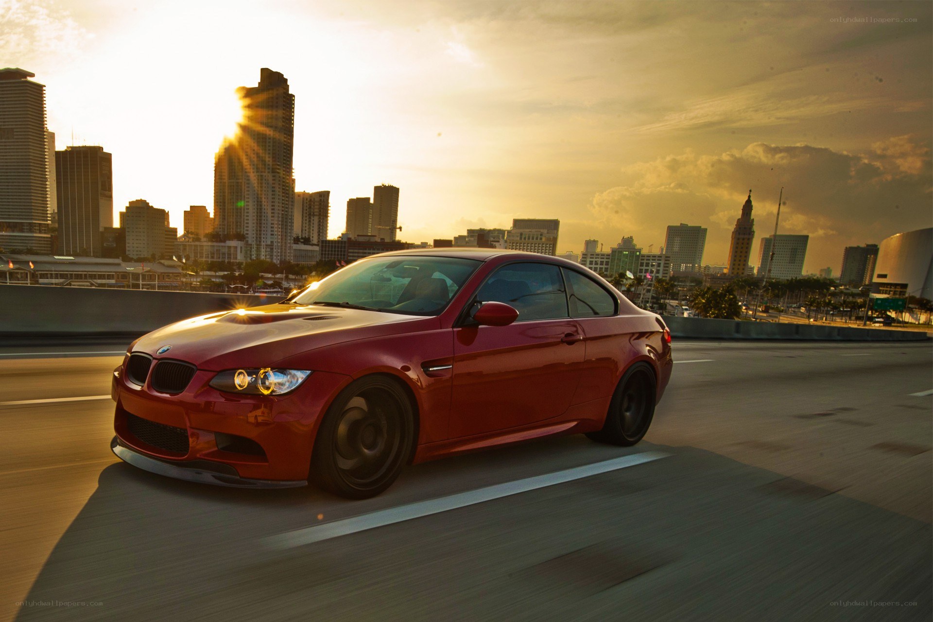 Red BMW on city highway