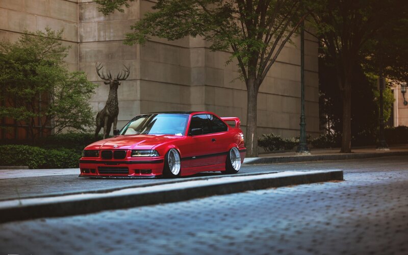 Red BMW on city street