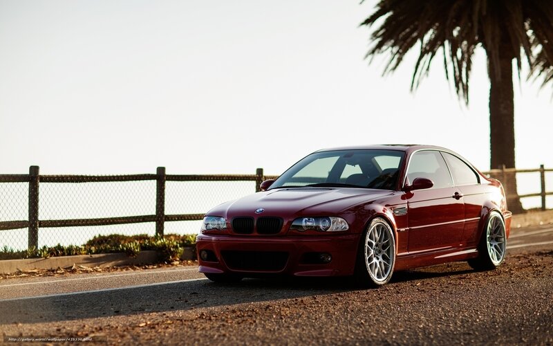 Red BMW on coastal road