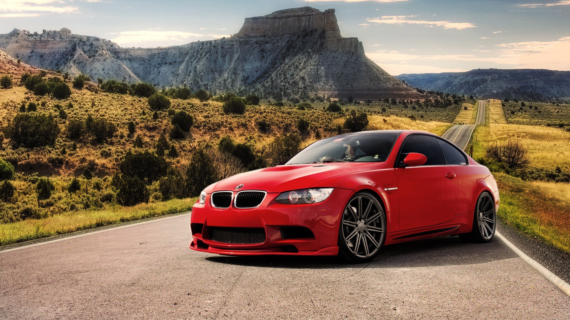 Red BMW on desert road