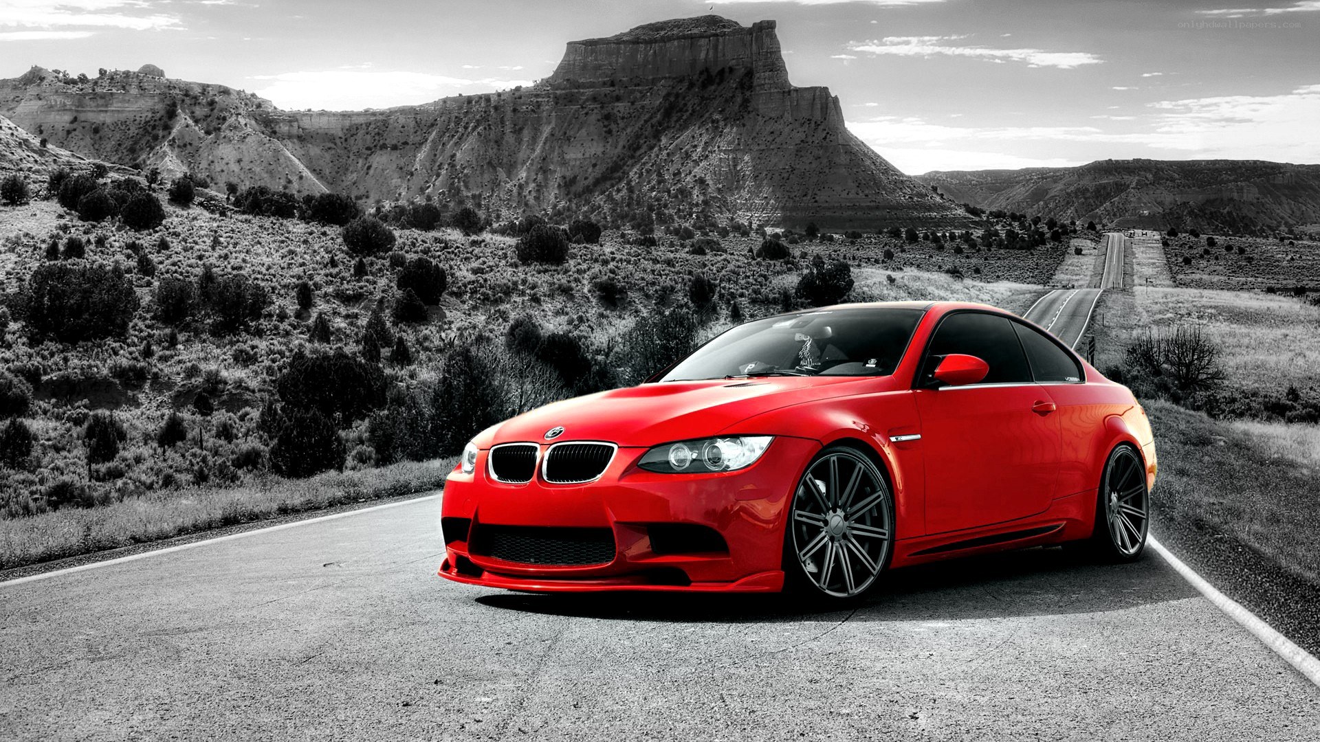 Red BMW on desert road