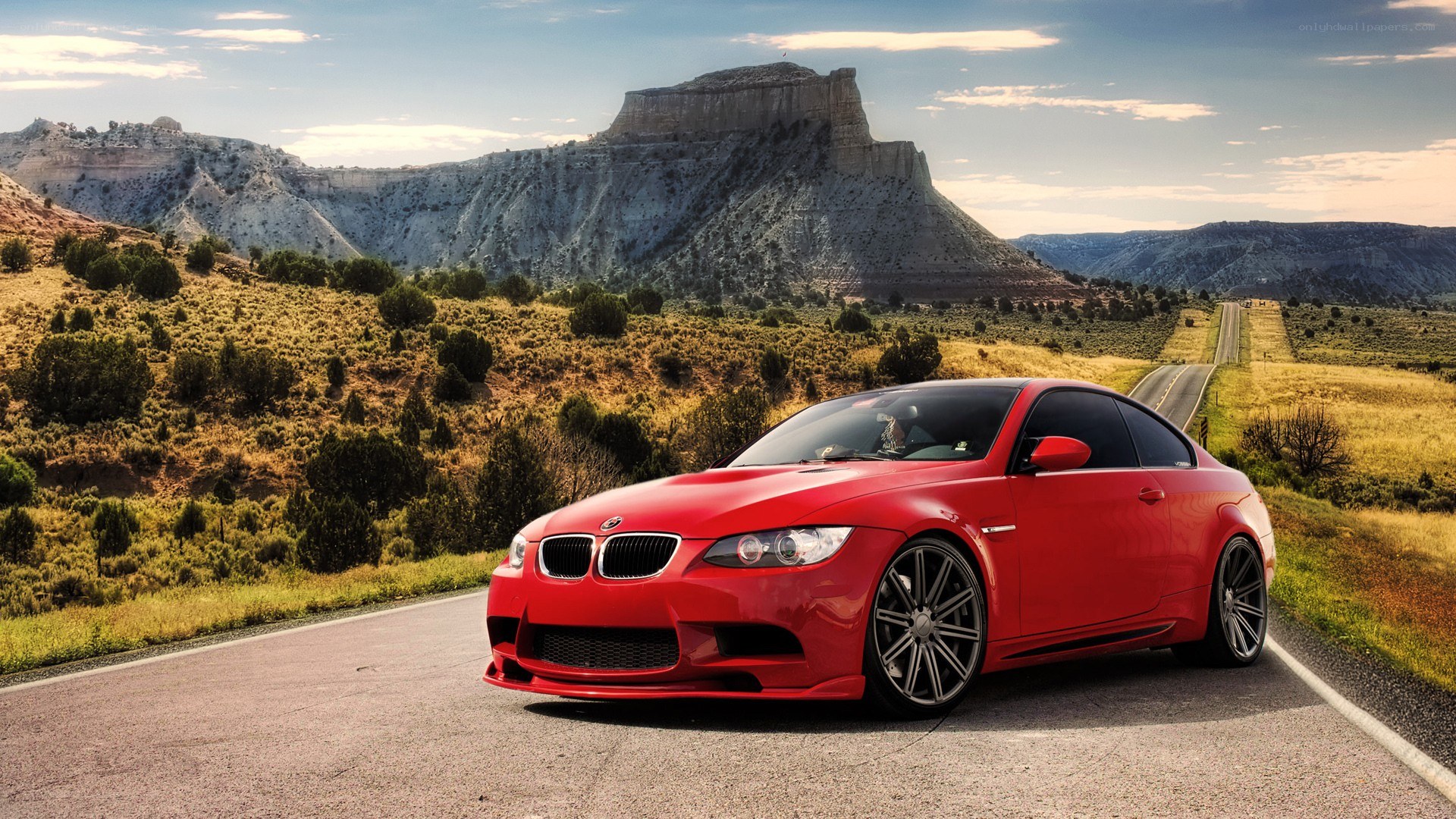 Red BMW on desert road