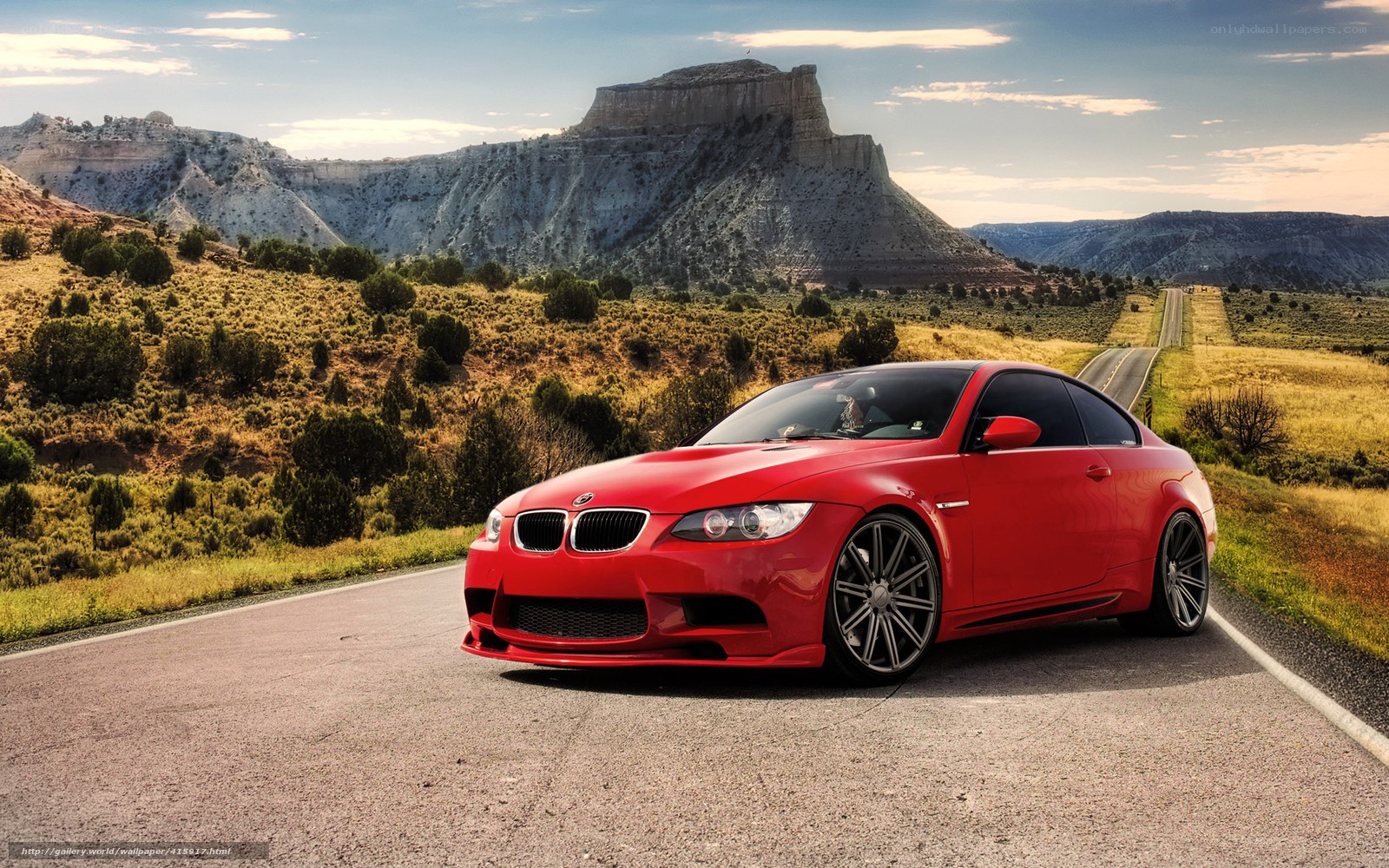 Red BMW on desert road