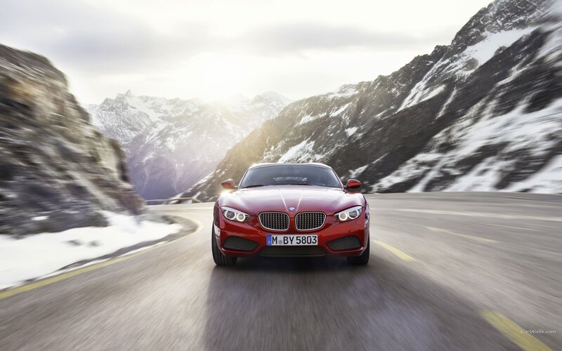 Red BMW on mountain road