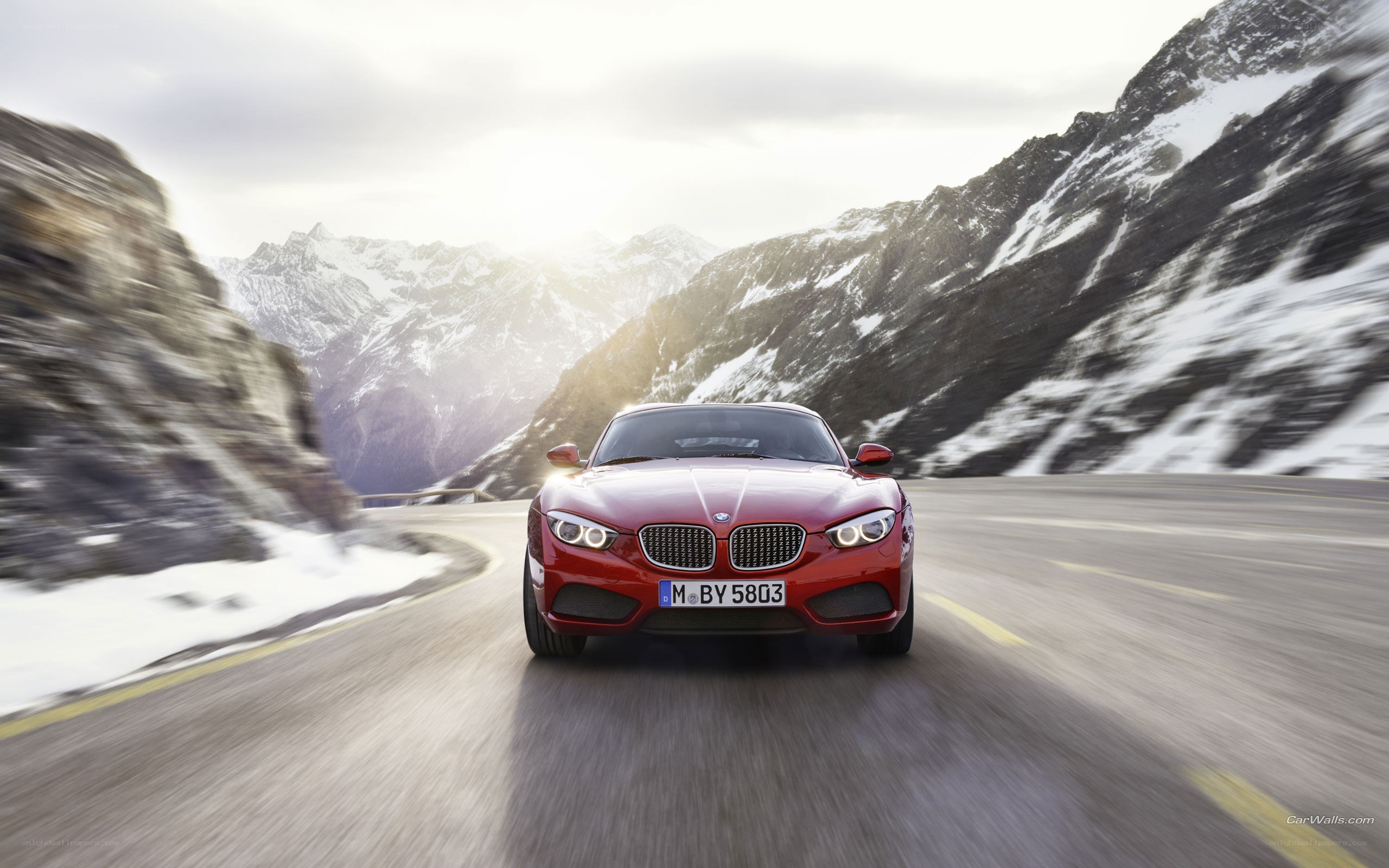 Red BMW on mountain road
