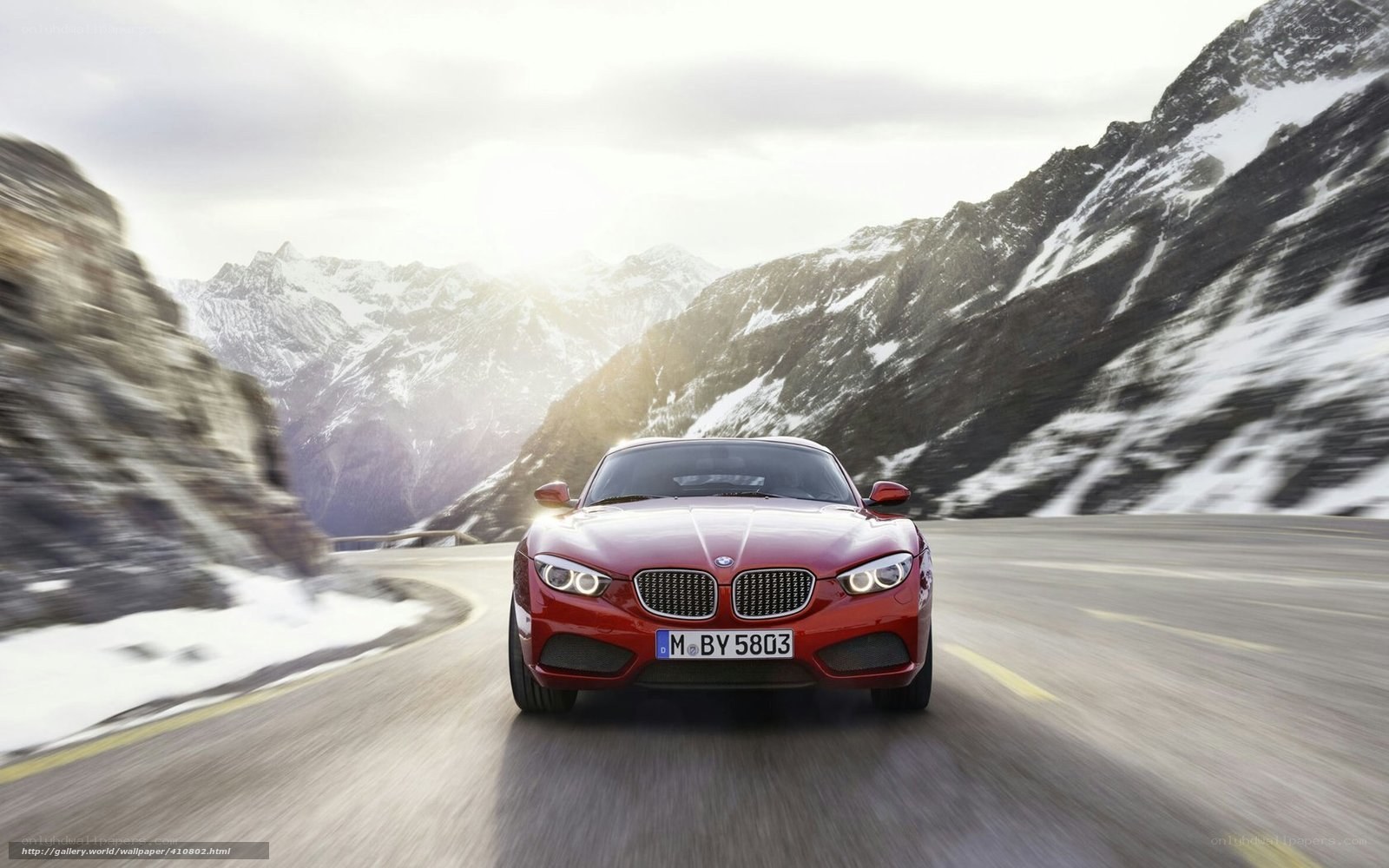 Red BMW on mountain road