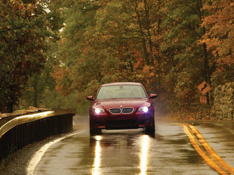 Red BMW on wet autumn road