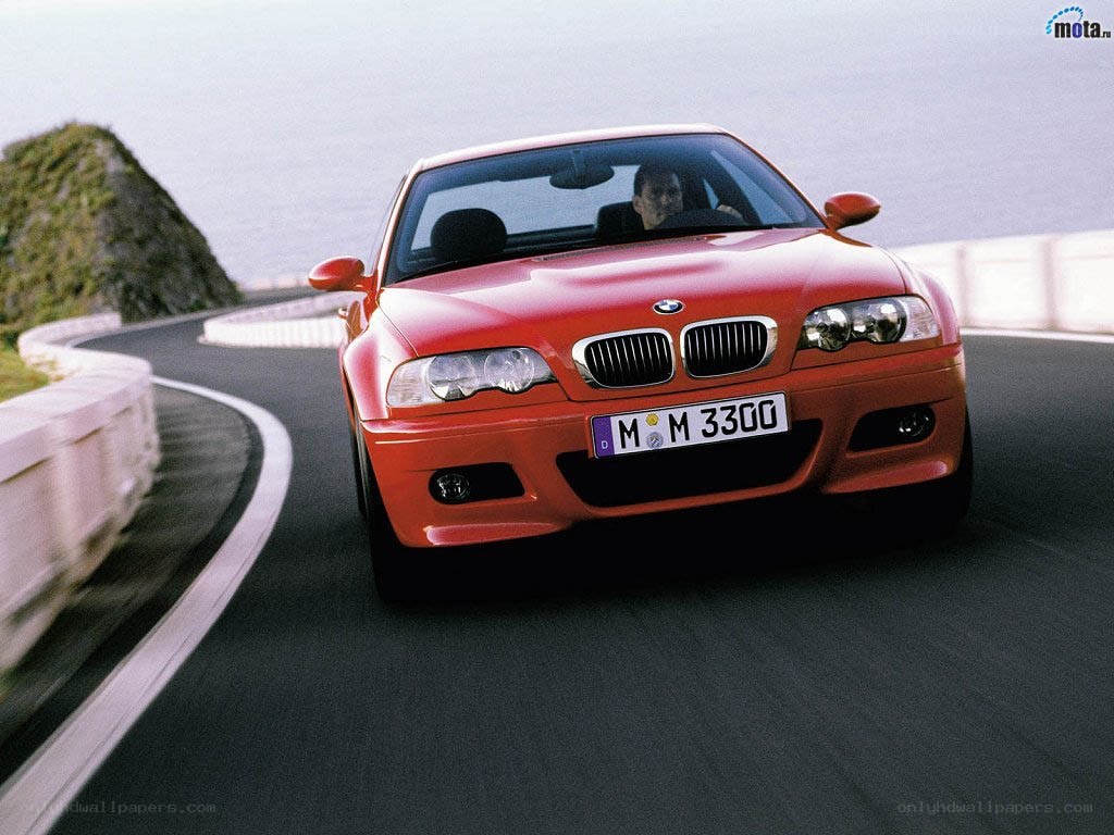 Red BMW on winding road