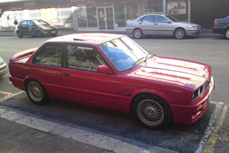 Red BMW parked on street