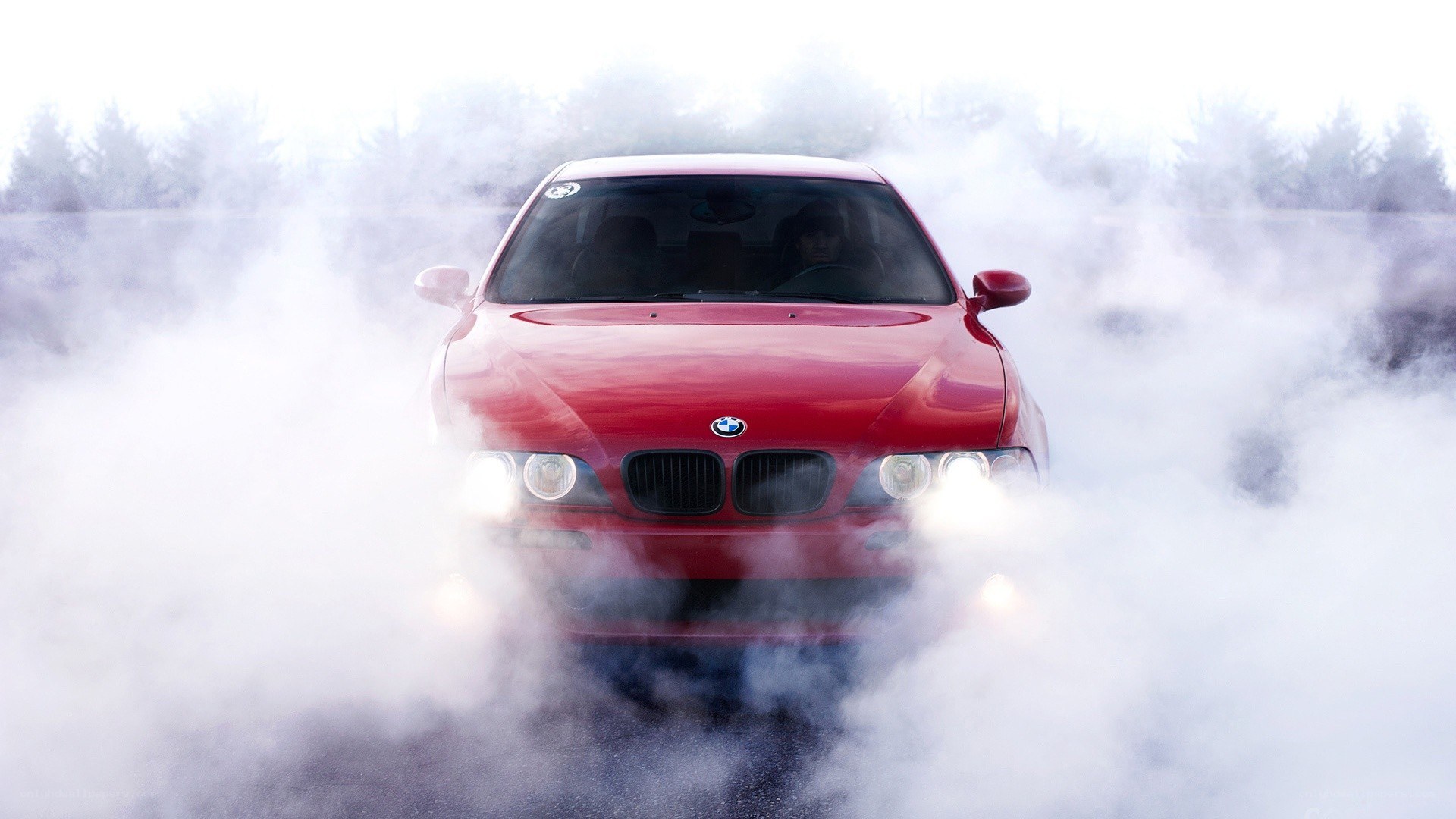 Red BMW performing burnout