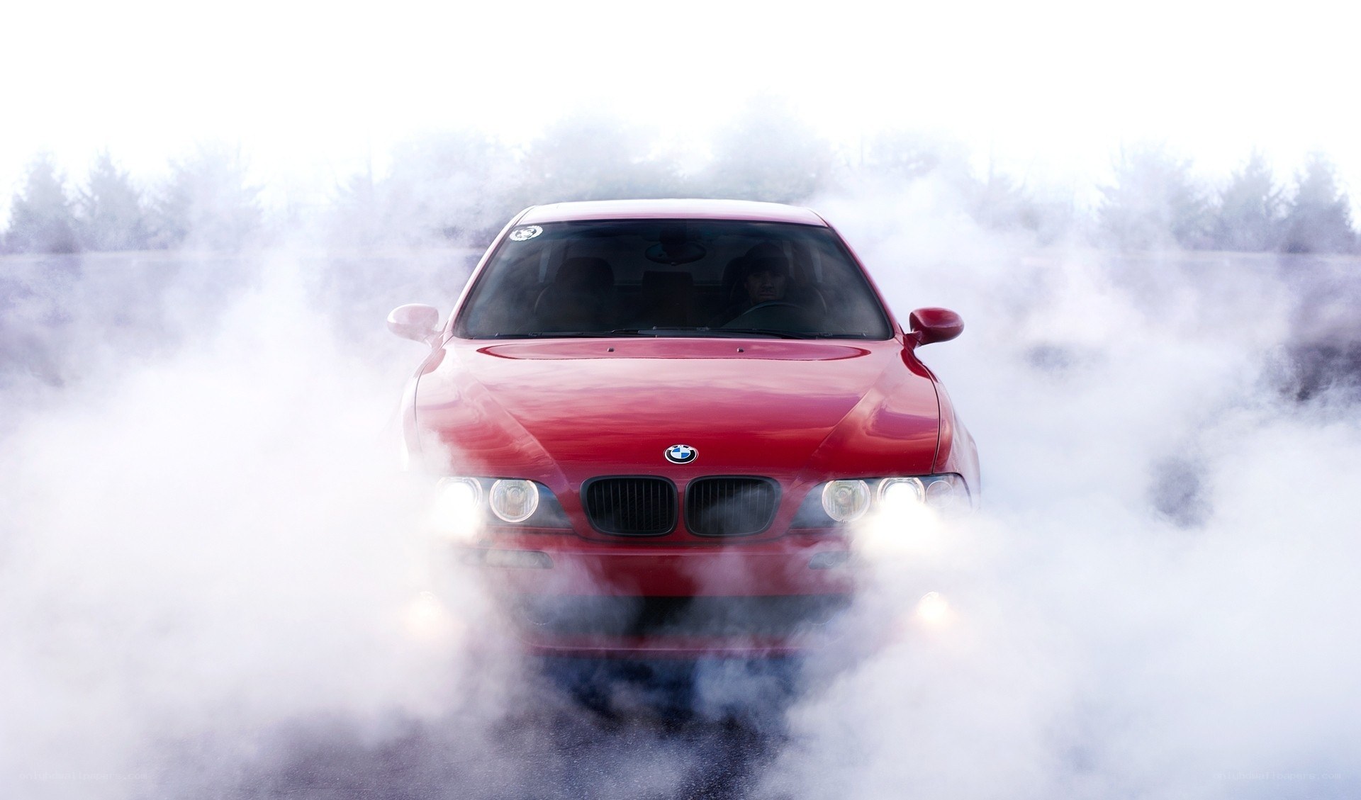 Red BMW performing burnout