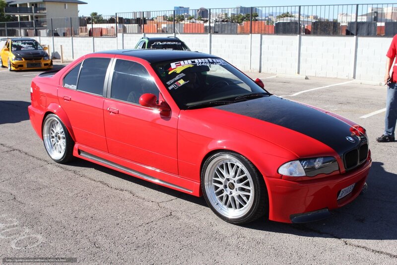 red bmw sedan at car show