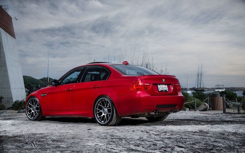 red bmw sedan by the harbor