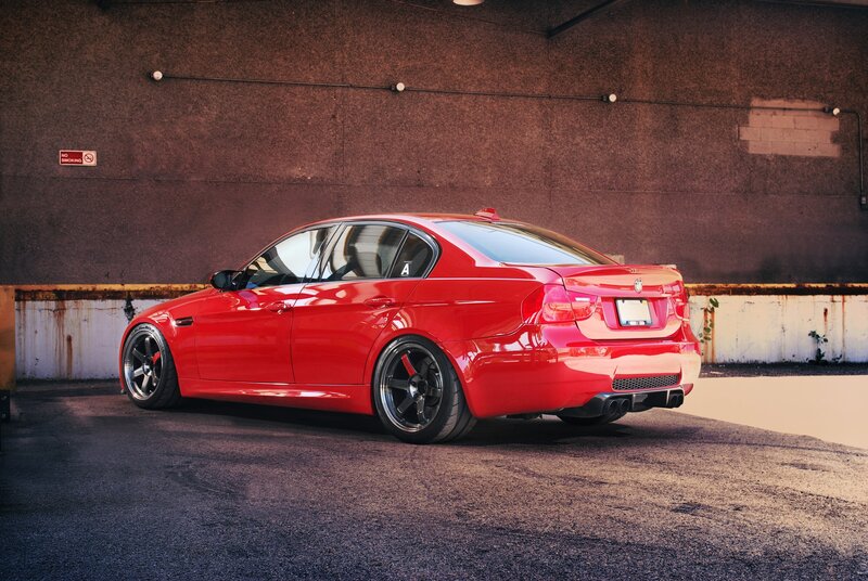 red bmw sedan in garage
