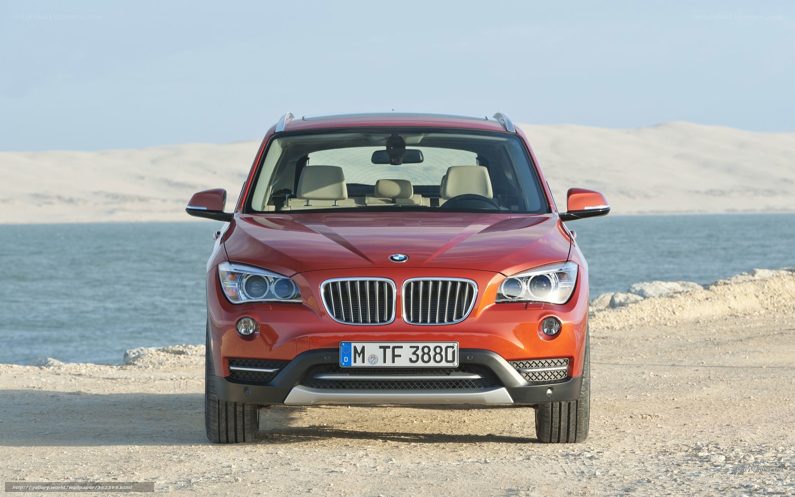Red BMW X1 by the sea
