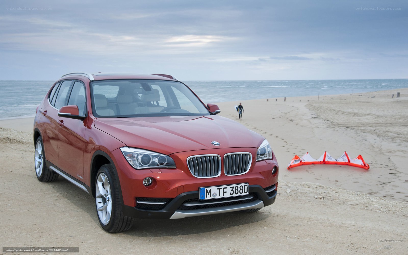 Red BMW X1 on a beach