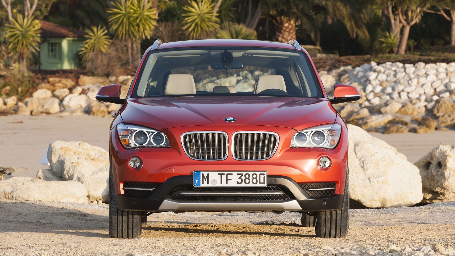 Red BMW X1 on a beach