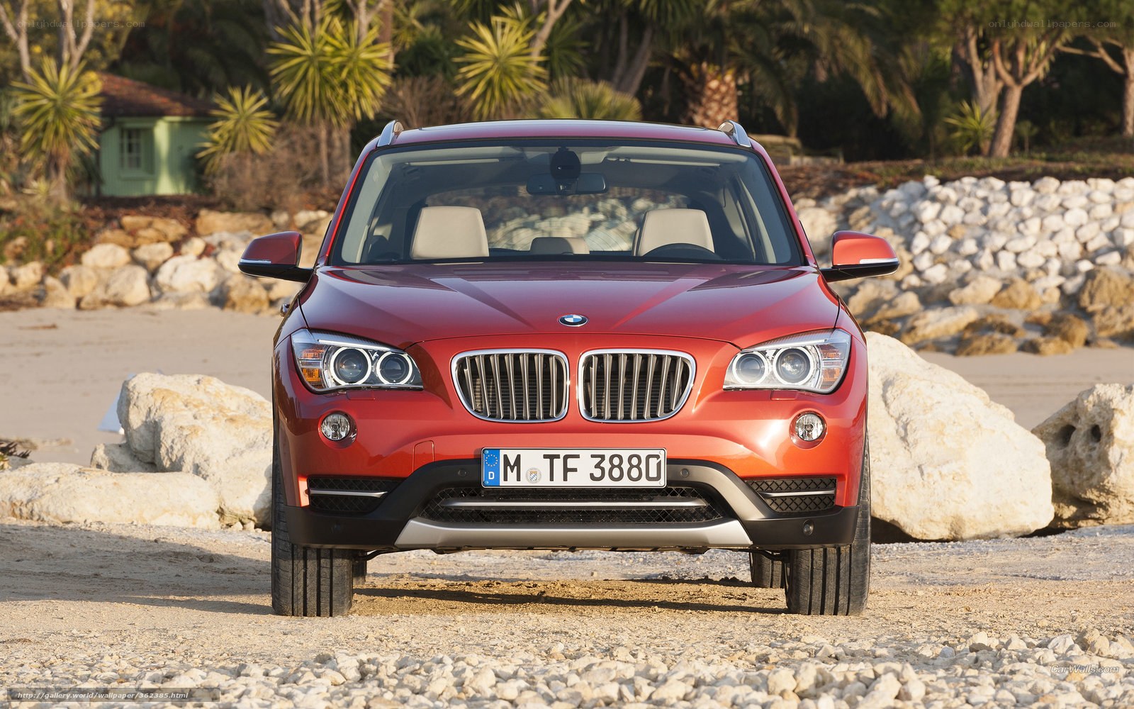 Red BMW X1 on a beach