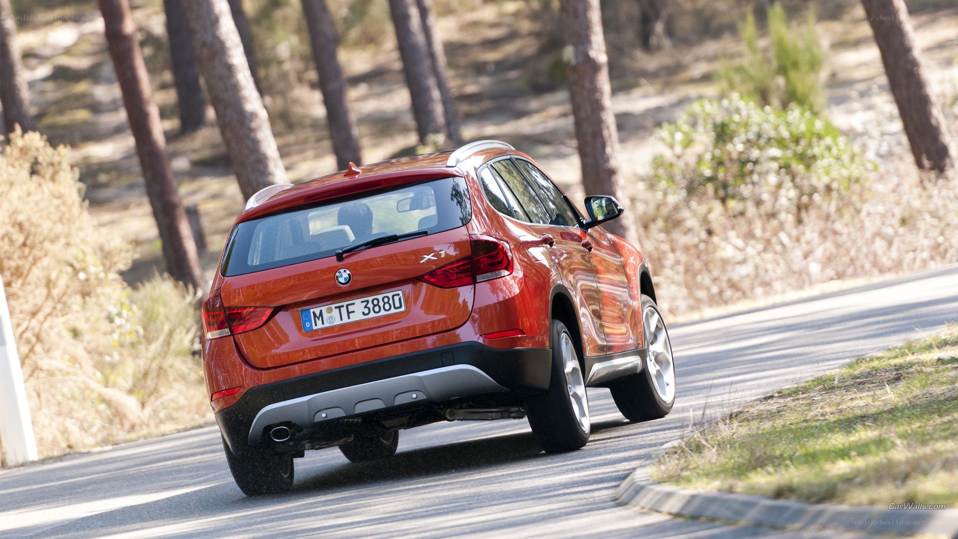 red bmw x1 on a winding road