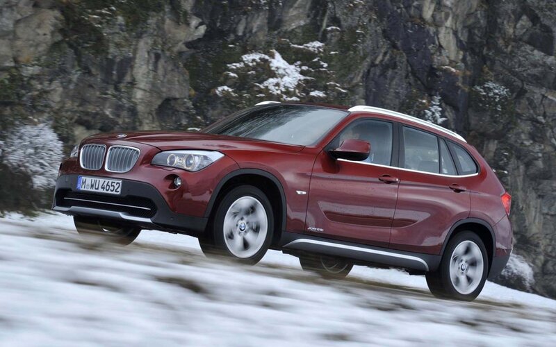Red BMW X1 on snowy road