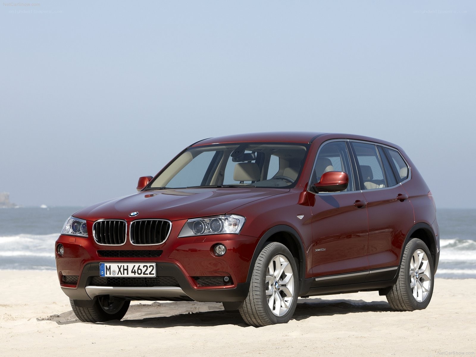 Red BMW X3 on a beach