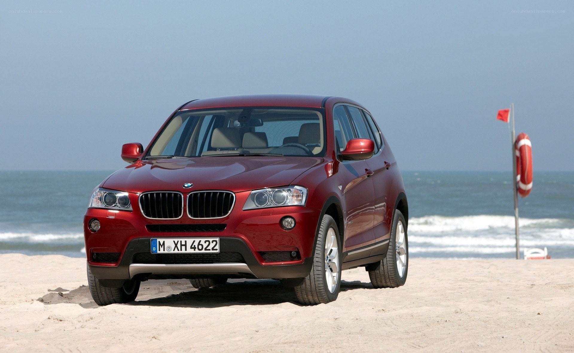 Red BMW X3 on a beach