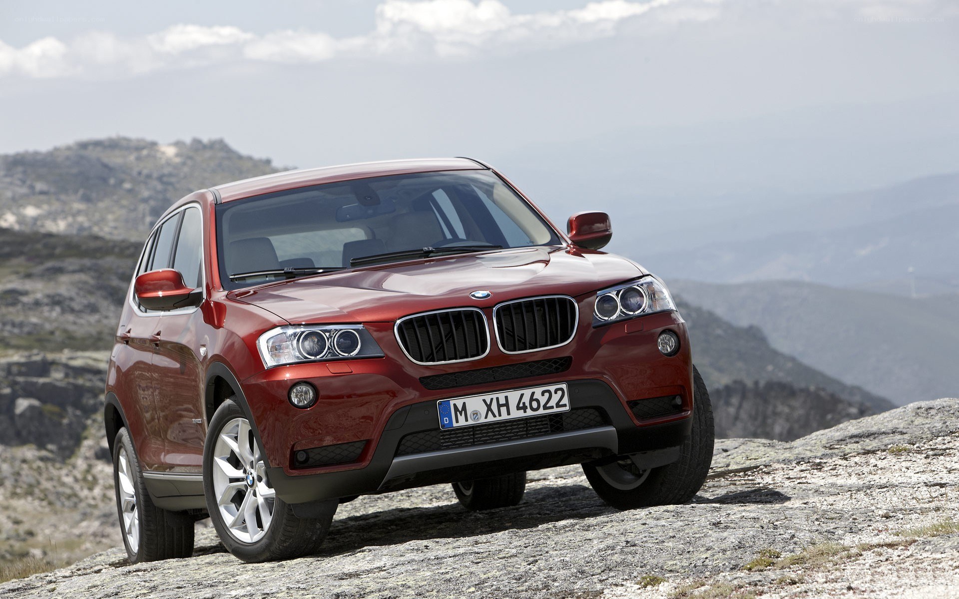 Red BMW X3 on a mountain