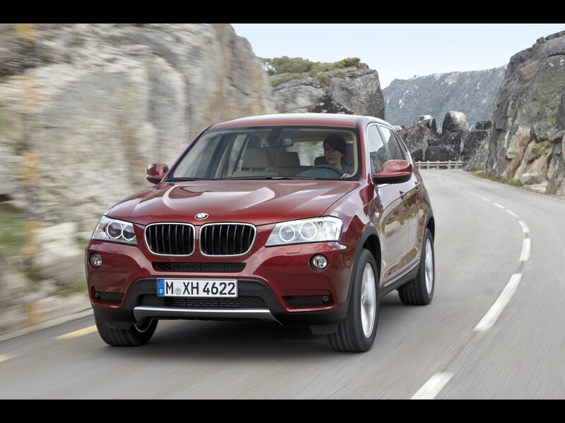 Red BMW X3 on mountain road