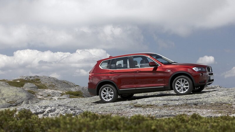 Red BMW X3 on rocky terrain