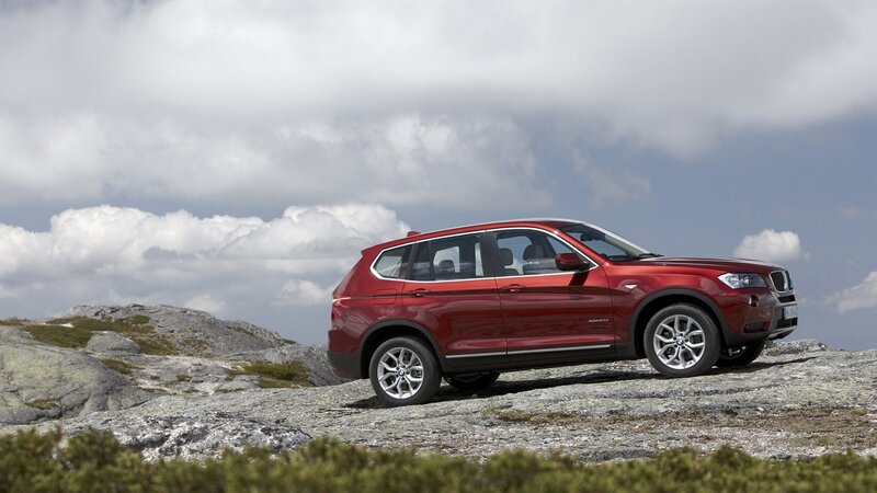 Red BMW X3 on rocky terrain