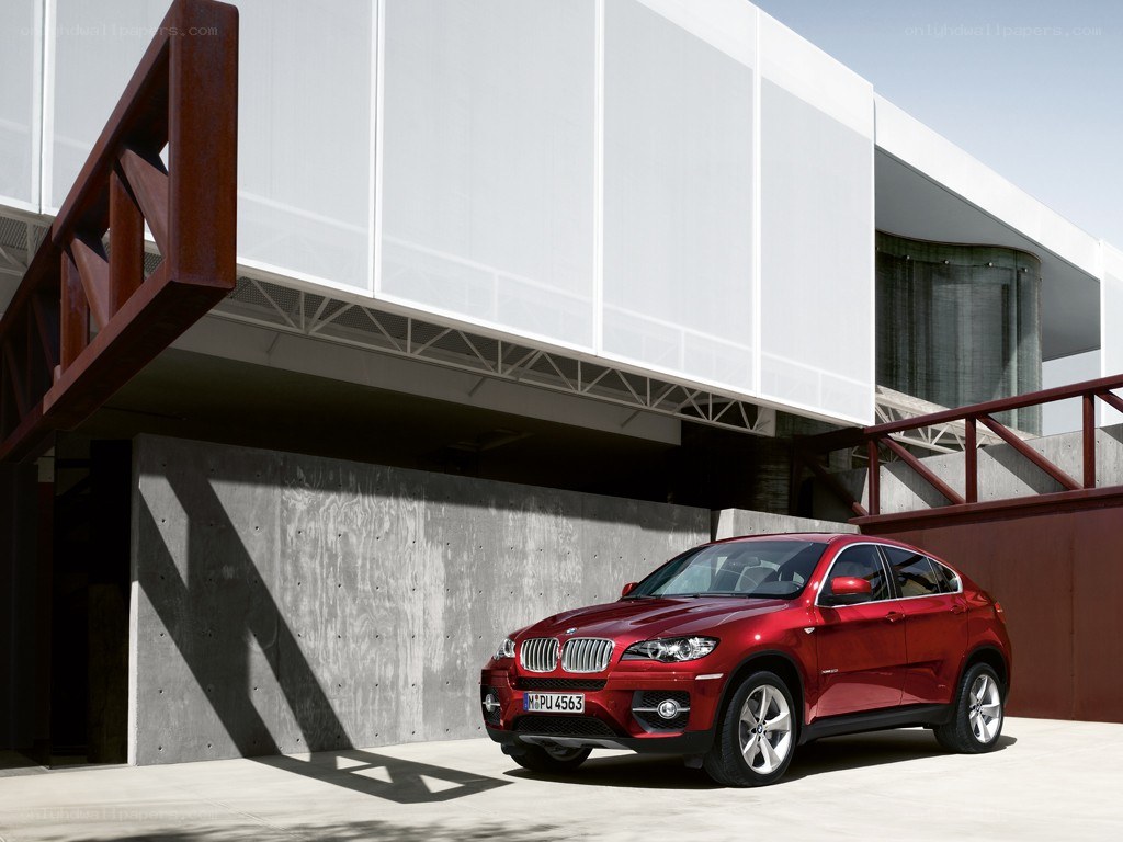Red BMW X6 in modern setting