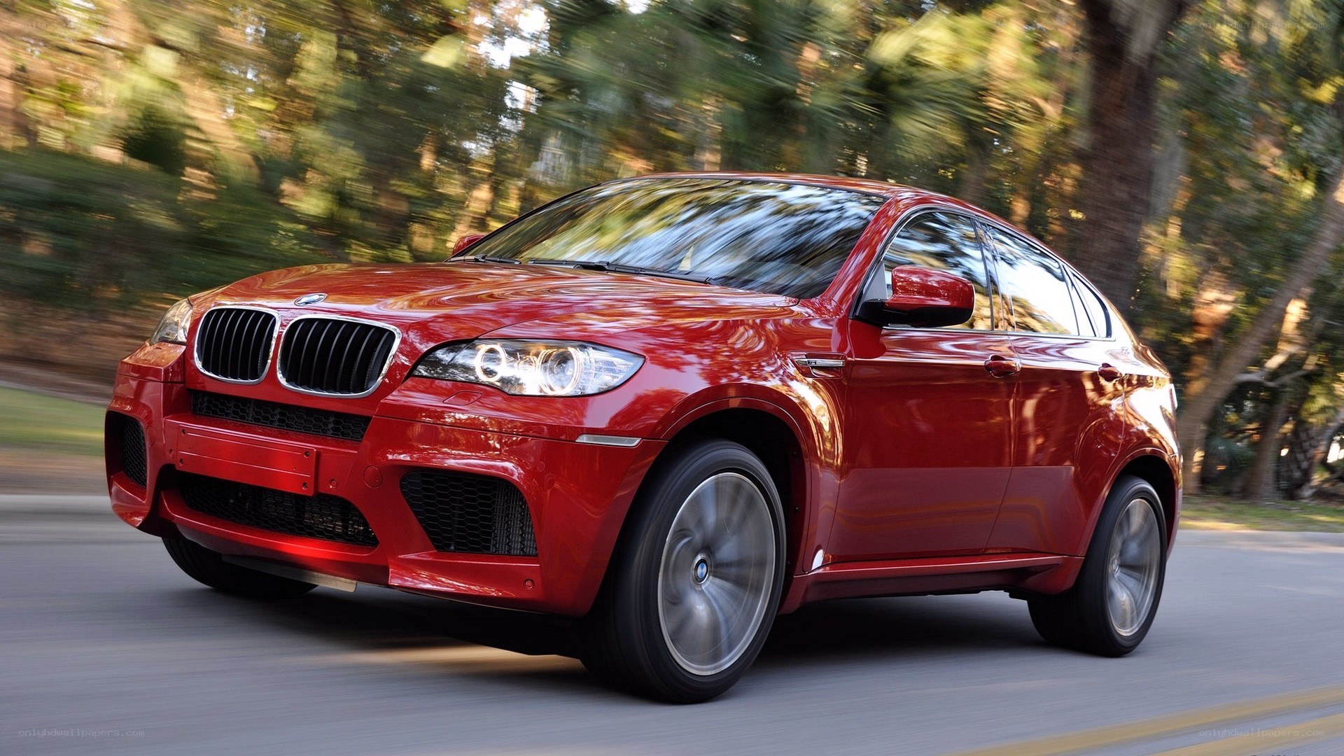 Red BMW X6 in motion