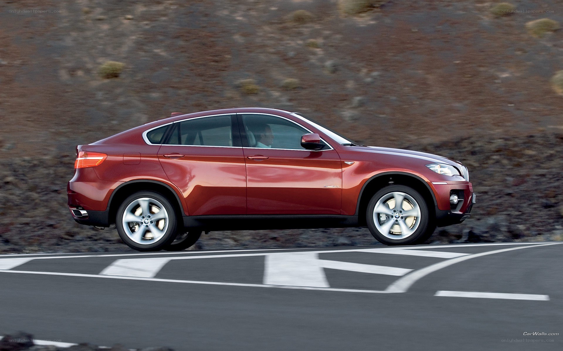 Red BMW X6 in motion