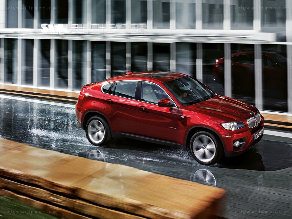 Red BMW X6 in motion