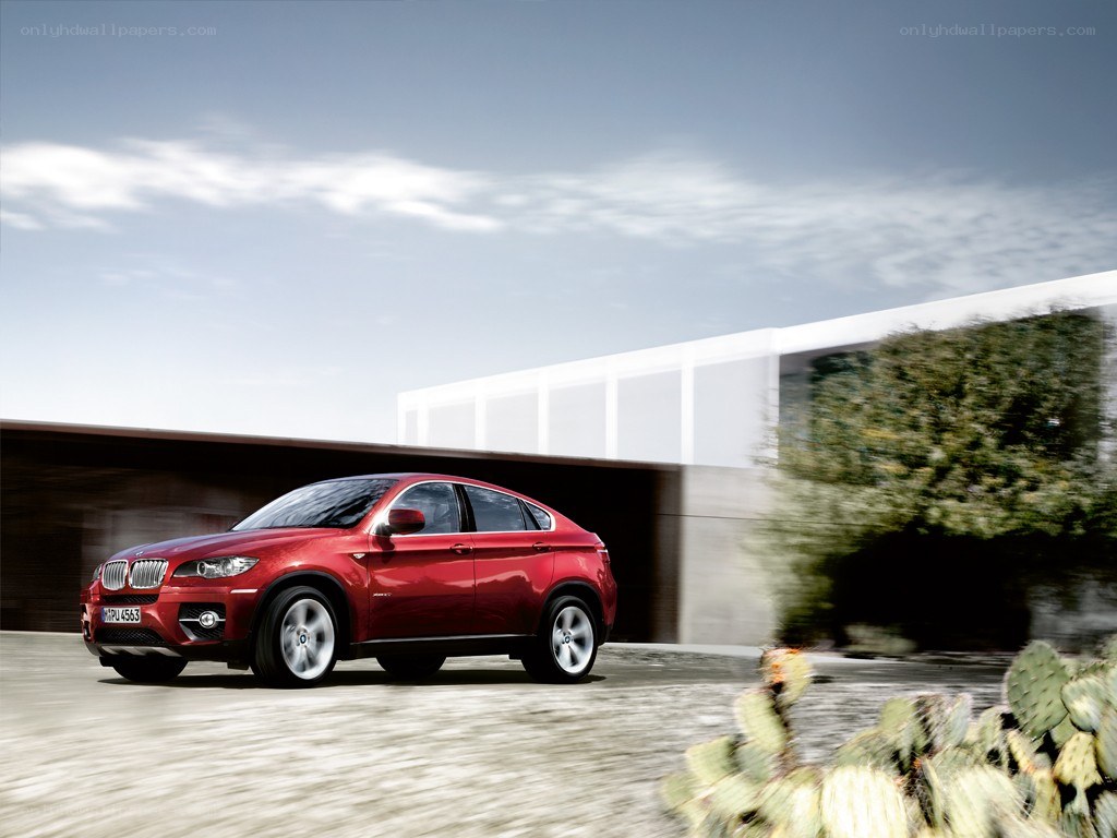 Red BMW X6 in motion