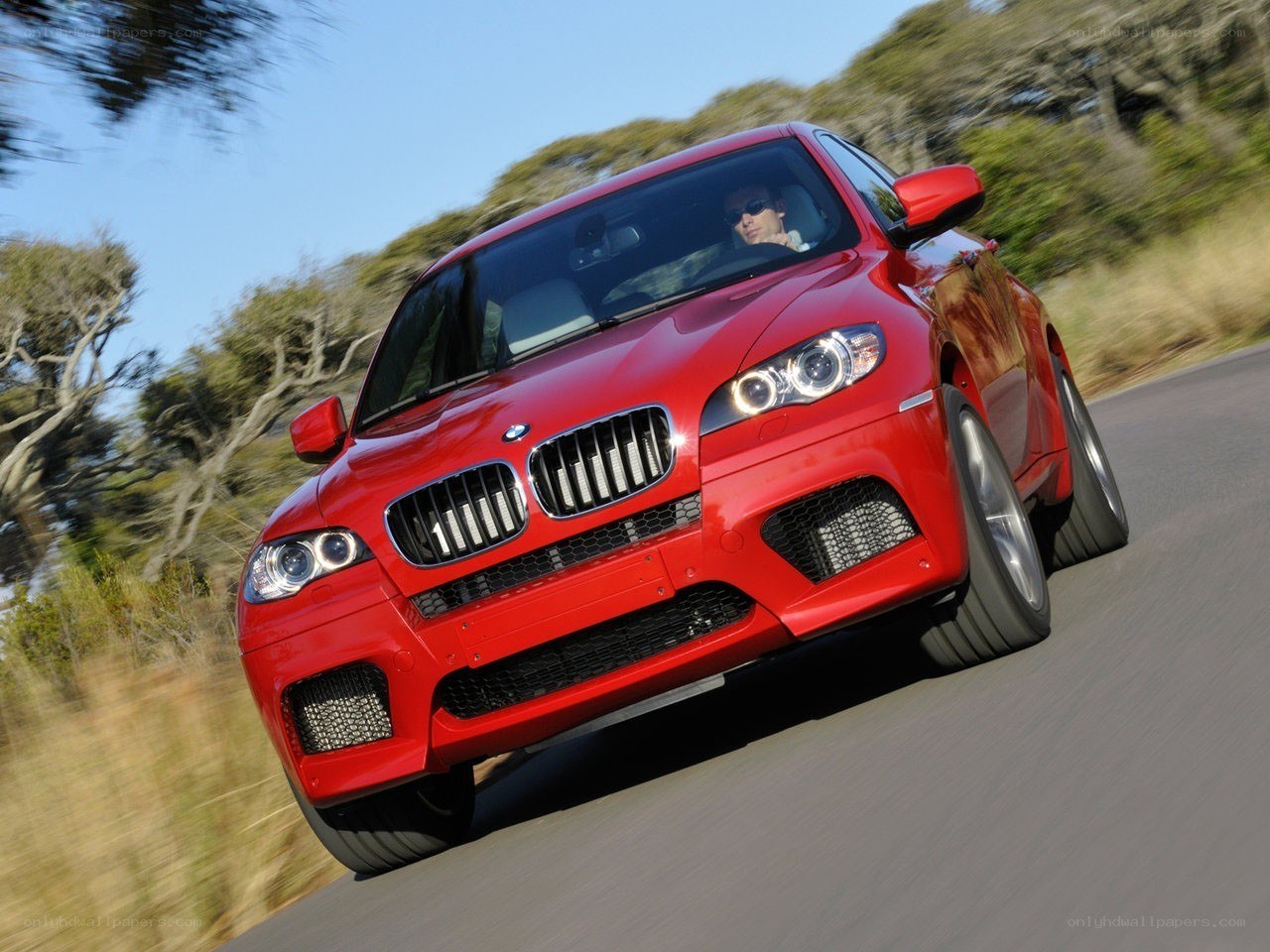 Red BMW X6 in motion