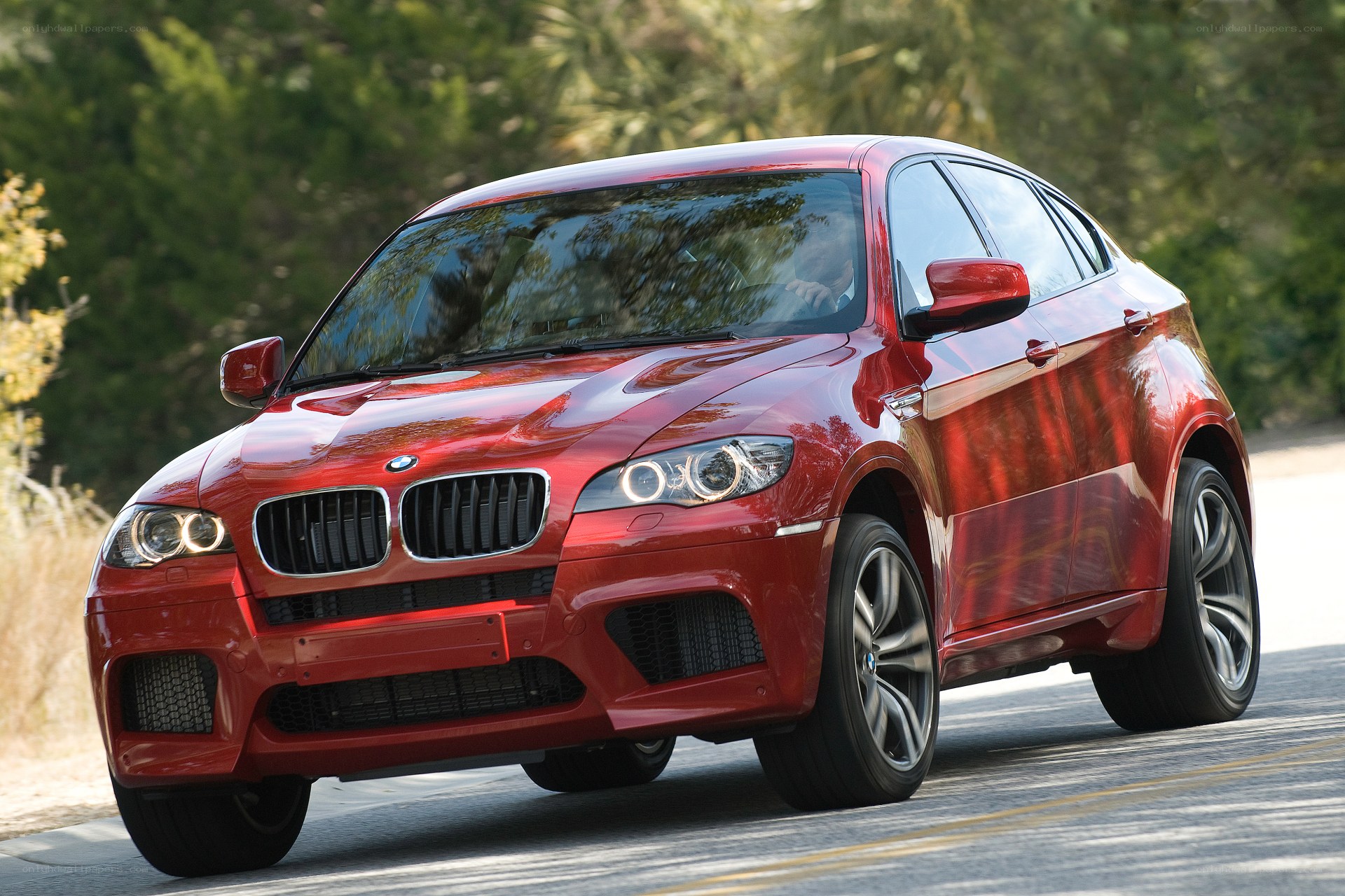 Red BMW X6 in motion