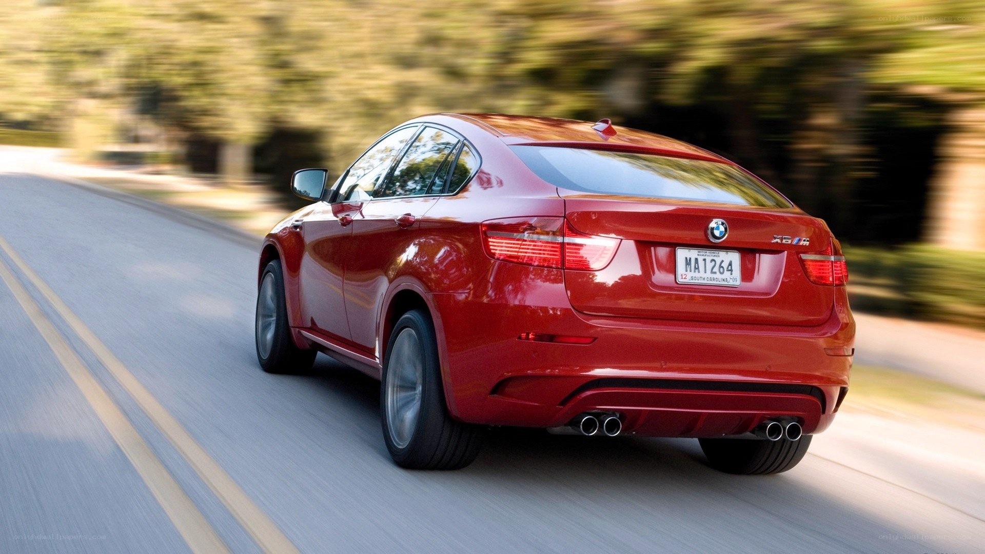 red bmw x6 m in motion