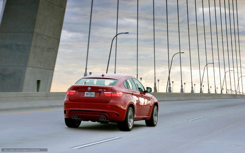Red BMW X6 M on a bridge
