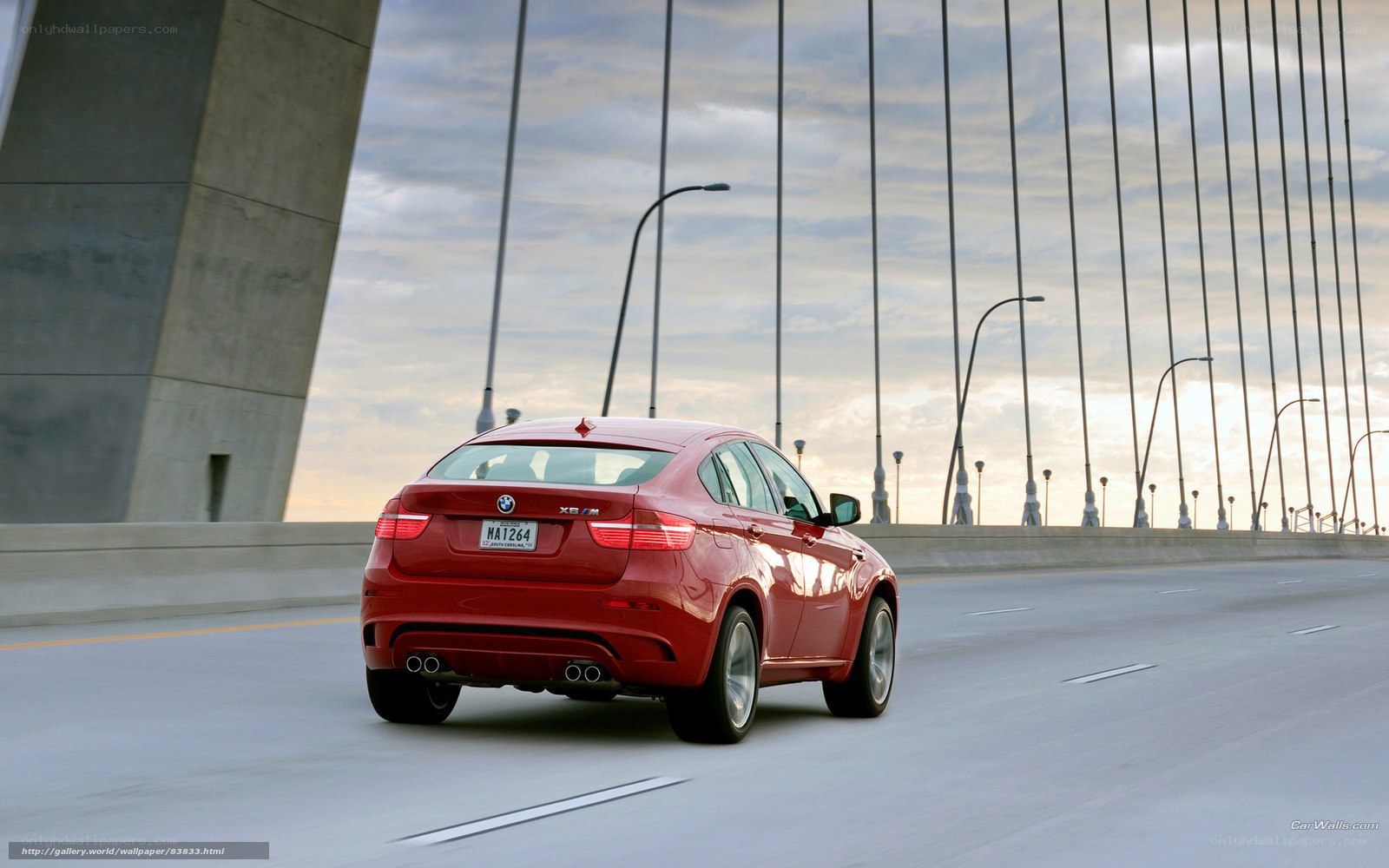 Red BMW X6 M on a bridge