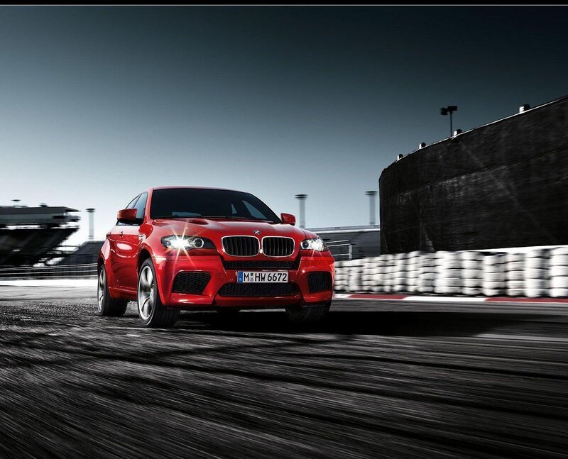 Red BMW X6 M on a racetrack