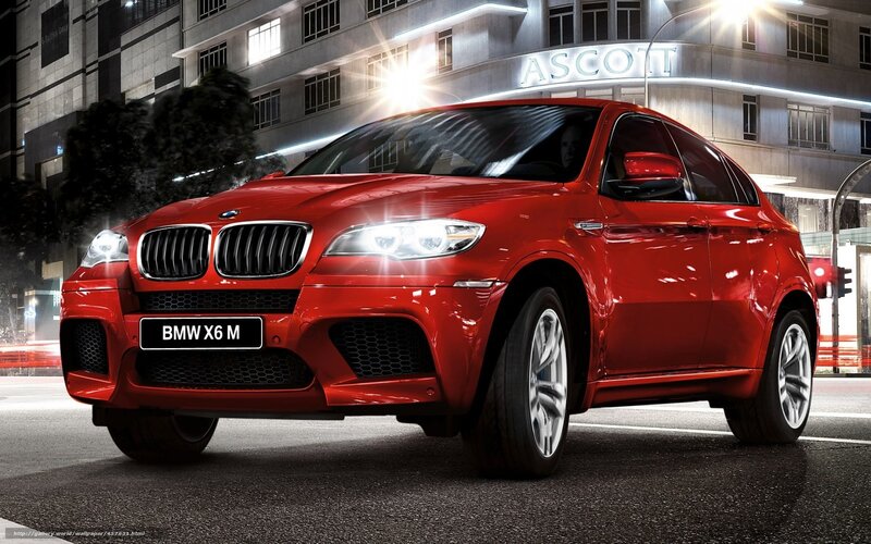Red BMW X6 M on city street