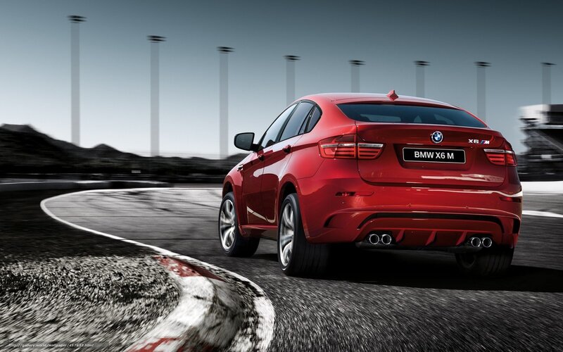 Red BMW X6 M on racetrack