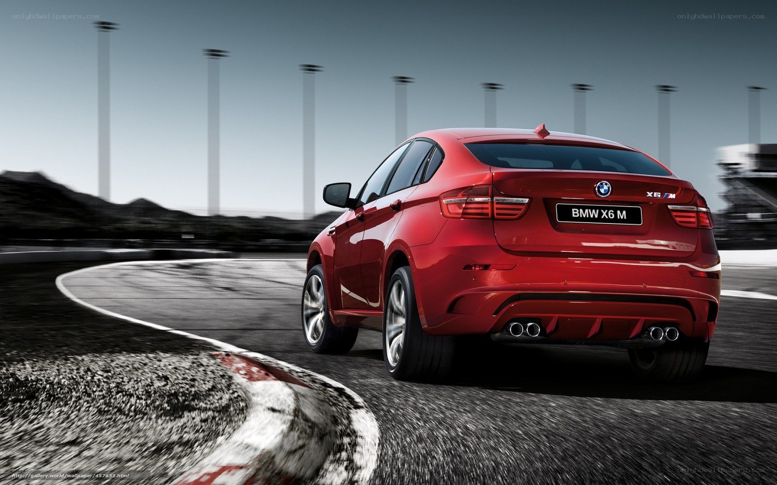 Red BMW X6 M on racetrack