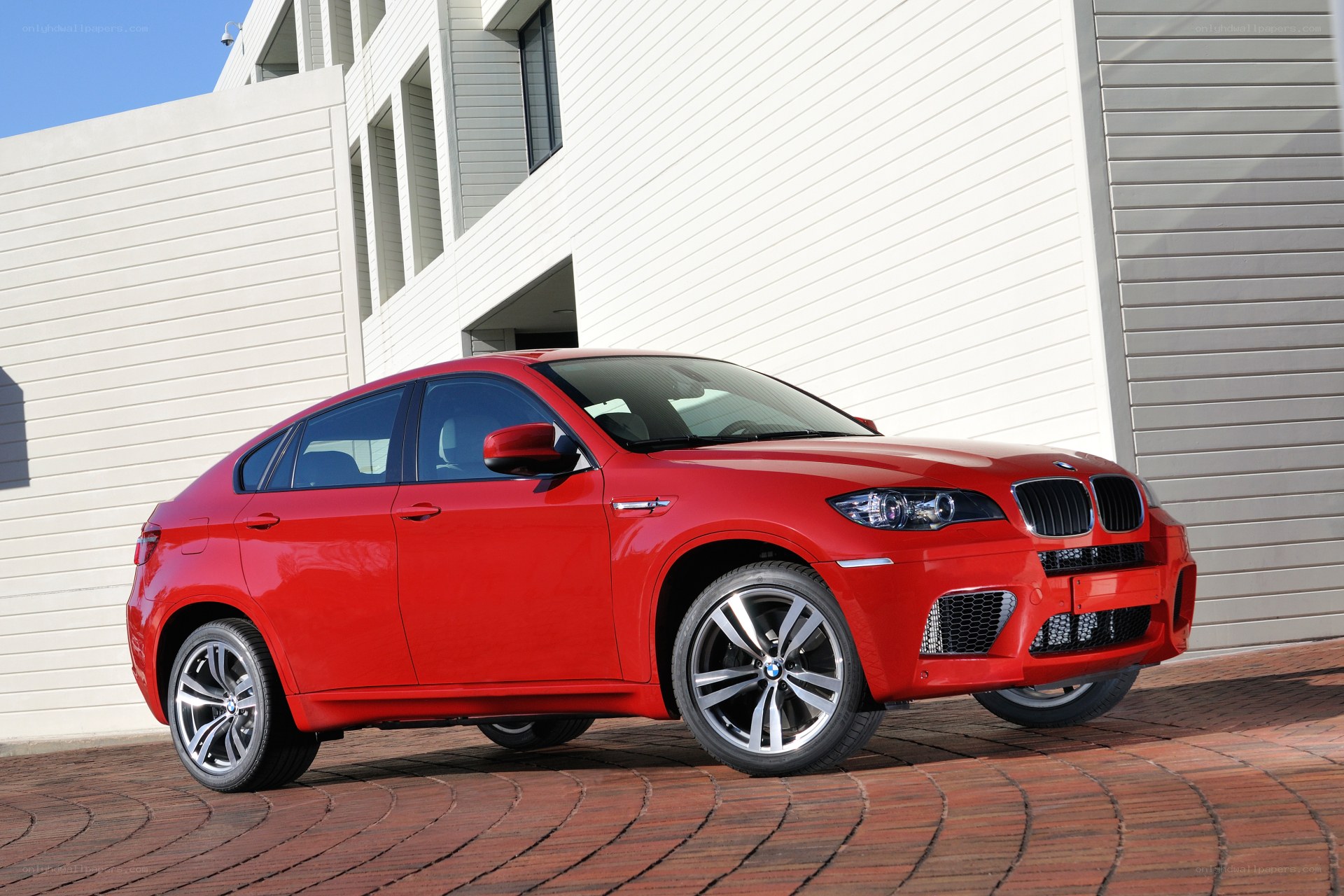 Red BMW X6 M parked outside