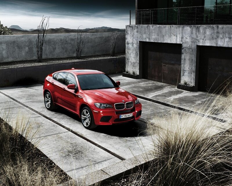 Red BMW X6 M parked outside