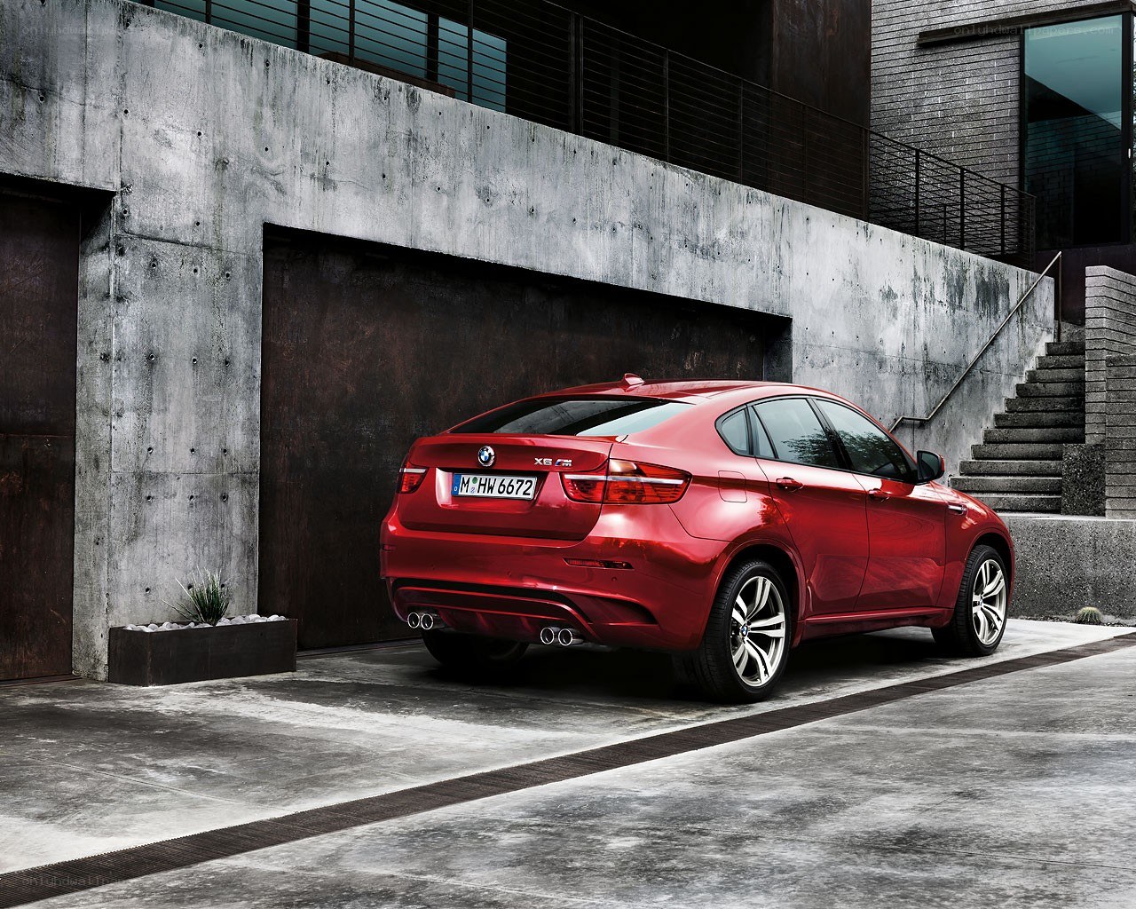 Red BMW X6 M parked outside